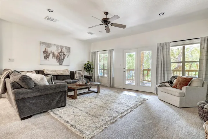 Upstairs living room or flexspace with doors to the balcony overlooking the pool area