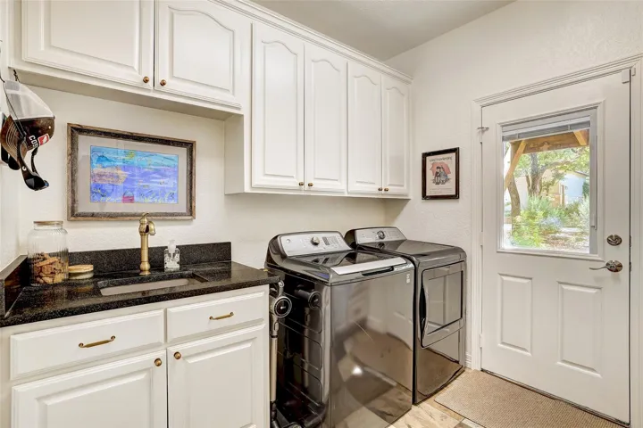 Main level laundry room with door to backyard