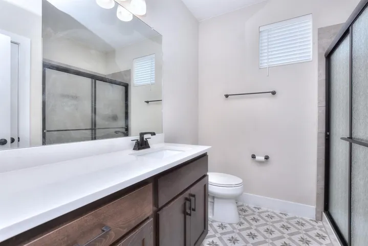 Bathroom with vanity and a stall shower between the front bedrooms