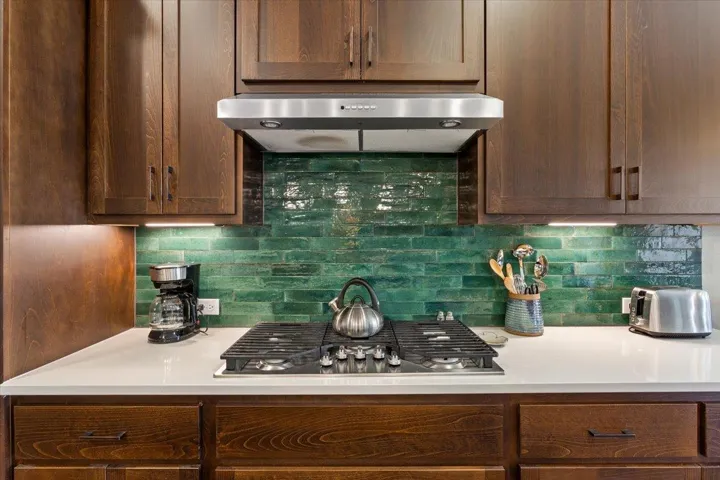 Kitchen featuring gas range, tasteful backsplash