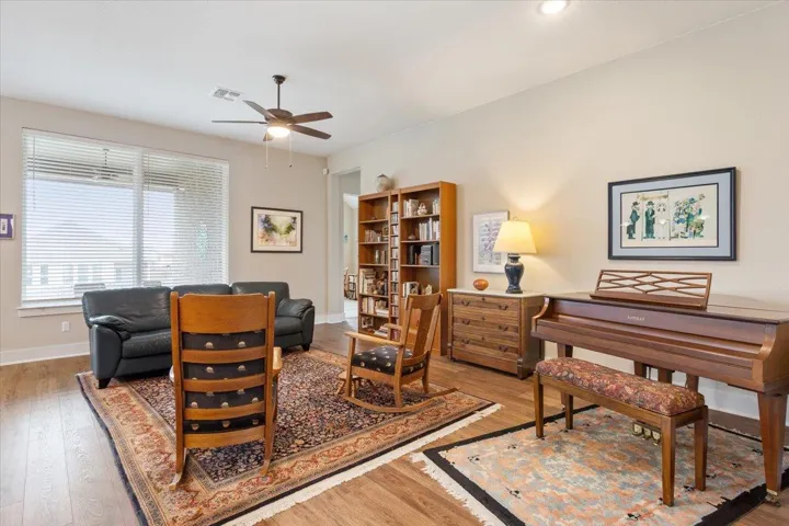 Sitting room featuring LVP floors and a ceiling fan