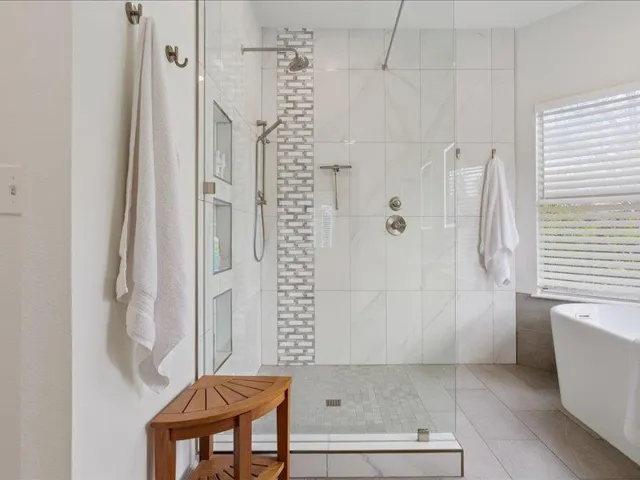 Primary bathroom featuring a soaking tub, tiled shower,