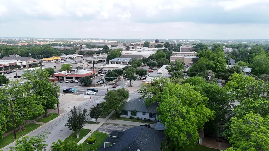 Expansive urban landscape featuring a mix of commercial buildings and residential structures