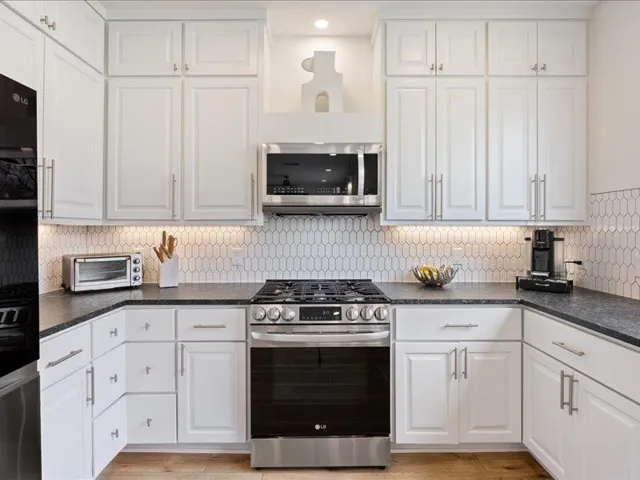 Kitchen with stainless steel appliances and white cabinets
