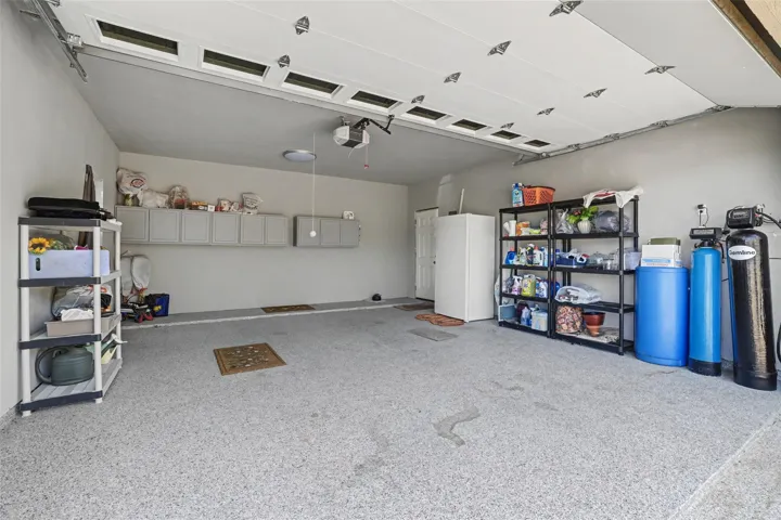 This is the detached 2 car garage; epoxy flooring; Fantastic room upstairs with exterior stairway entry;  currently being used as storage but ready easily ready for guest room
