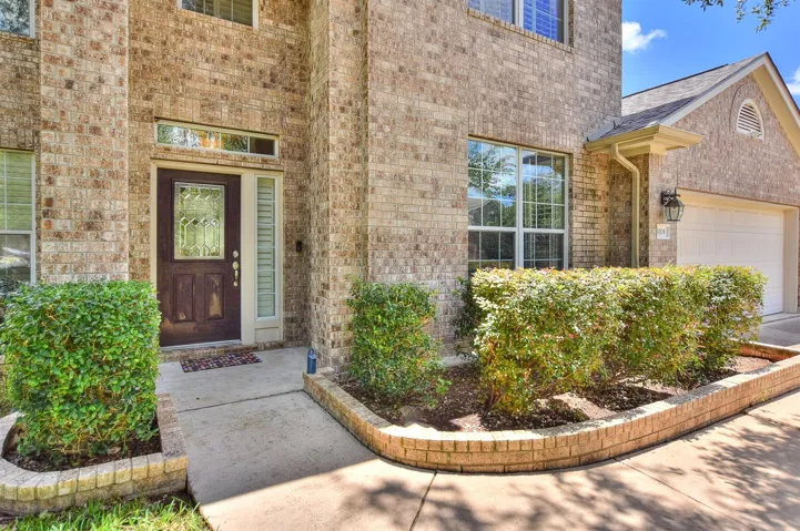 Lovely curb appeal with lush landscaping & bedding areas welcome you home!
