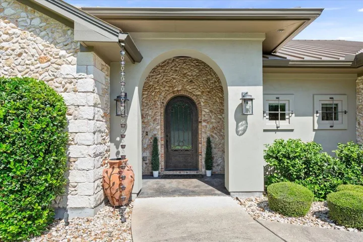 Doorway to property with stone siding and stucco siding.  Welcome Home!