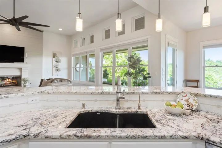 Don't feel left out doing the dishes in this double sink!  You have a perfect view of the dining area to the right and a straight on view of the living room, fireplace, & television.  You also have an amazing outside view from this vantage point...