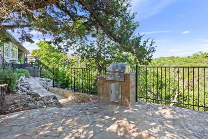 View of the third patio used for grilling and maybe having a beer while you're doing it!  The built in grill stays with the property.  The trees surrounding this deck have decorative lighting for nighttime...