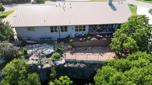 View of the rear of the home, the decks and the start of the tree view in back...