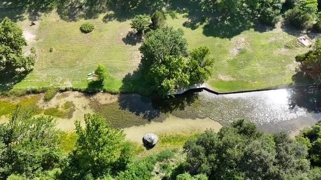 Aerial view of property and surrounding area. This photo is a view of the San Gabriel River at the tail end of the private hike & bike trail below the trees in Falls of San Gabriel...
