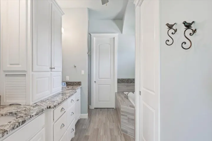 Bathroom with a garden tub, a separate shower, heated tile floors, double vanity & a large walk-in closet at the end...