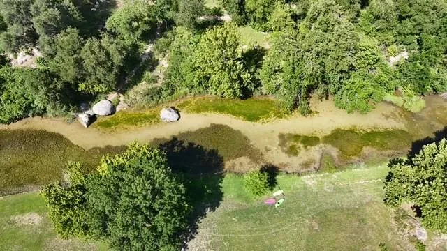 Drone / aerial view of the San Gabriel River at the end of the hike and bike trail from Falls of San Gabriel.