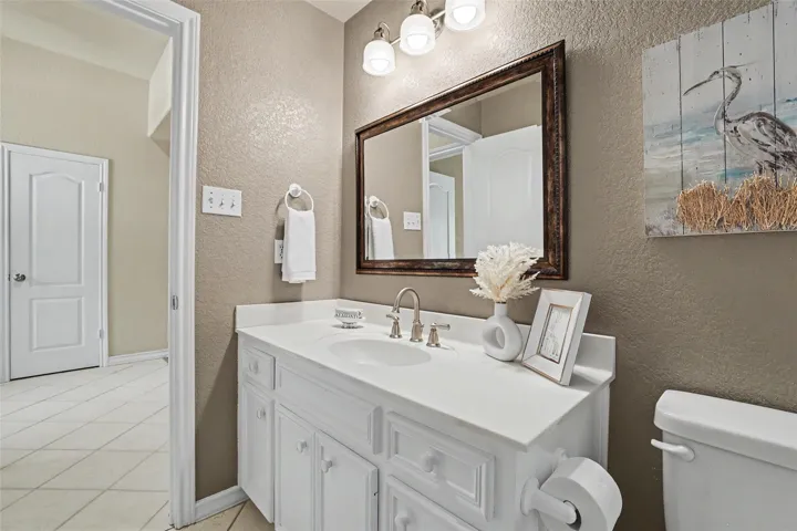 White vanity with a spacious countertop offers a crisp, clean aesthetic in this well-appointed bathroom.