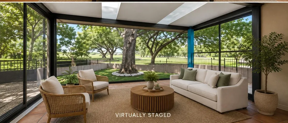 Floor-to-ceiling glass doors open this sunroom directly to views of the mature wooded landscape.