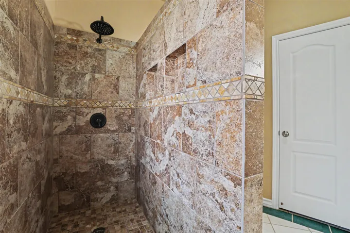 Experience daily refreshment in this beautifully tiled walk-in shower, offering convenience and style.