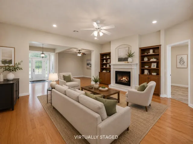 Gleaming hardwood floors and classic built-ins frame a fireplace in this welcoming living space.