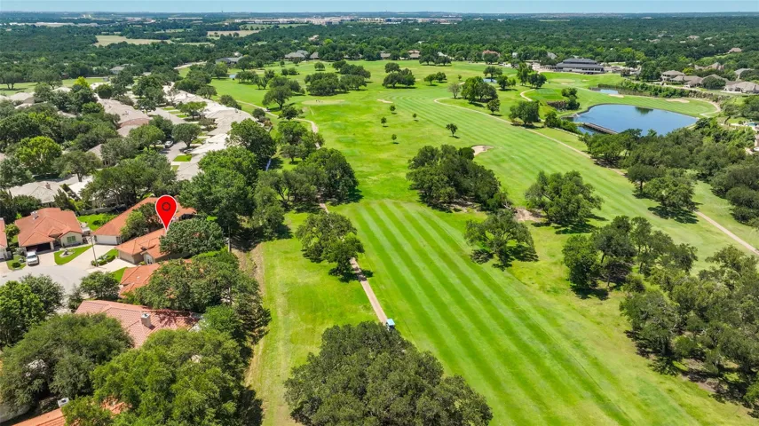 A golfer's paradise, this property offers serene views of the verdant fairways and a tranquil water feature.