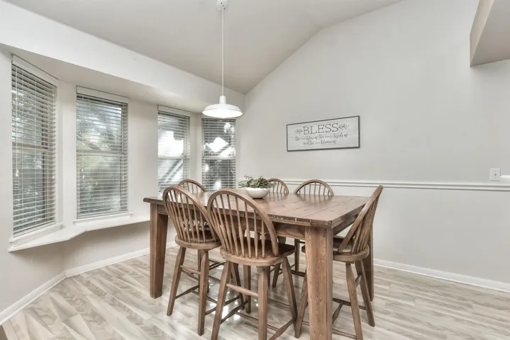 Charming breakfast area with bay window allowing natural light and views of the back yard and patio.