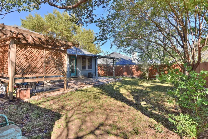 Nice rectangular backyard with multiple extended paved patio areas