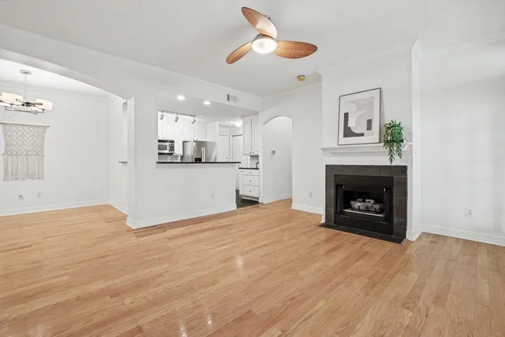 A refined living space showcasing gleaming hardwood flooring and a cozy fireplace.