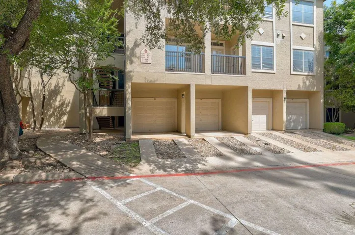 Multi-level living with convenient private garages and shaded entryways.
