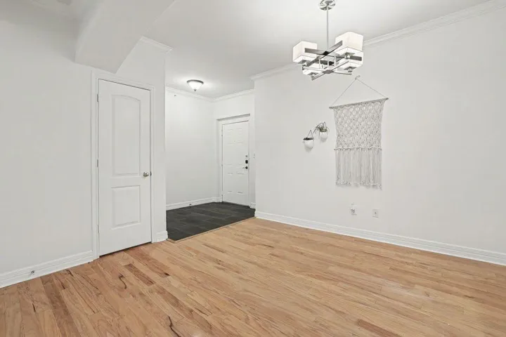 Blonde hardwood floors flow seamlessly into the tiled entry, creating a versatile and inviting living space.