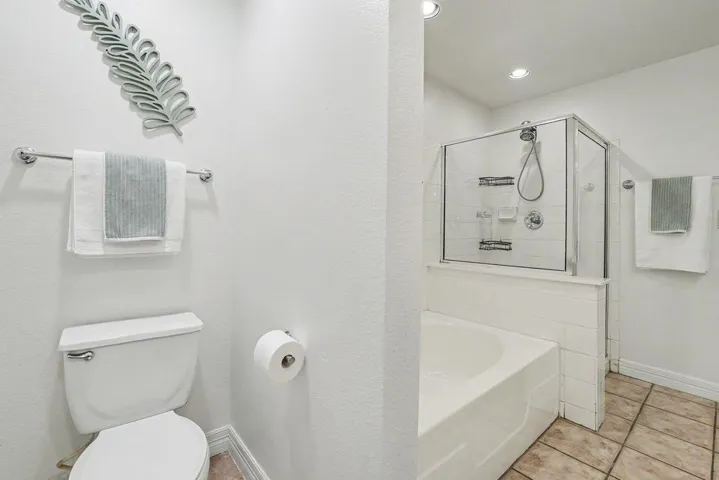 A well-appointed bathroom features a combined shower and bathtub for daily routines.