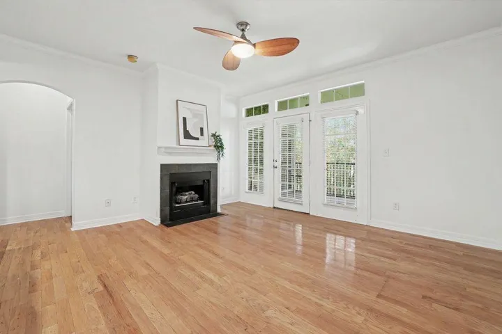 Sun-filled living space features warm hardwood floors and a modern fireplace, ideal for relaxed gatherings.
