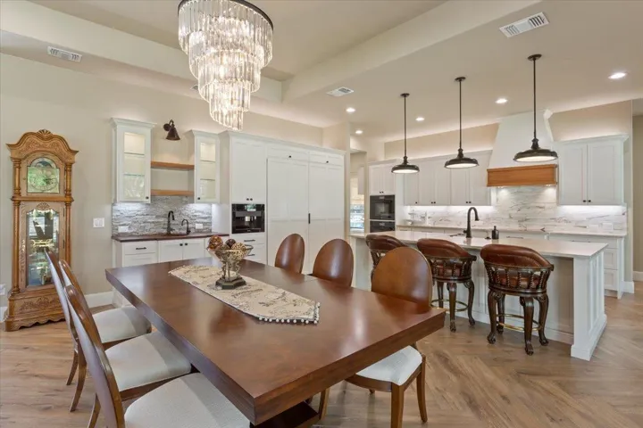The table & chairs shown here seat 8.  The dining room could easily seat 10-12 plus the breakfast bar area just behind the table...The chandelier?  Divine!