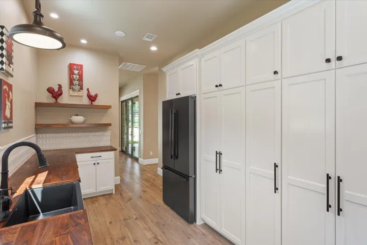 And on the other side of the Butler's Pantry, there are cabinets of pantry shelves for canned & dry goods.  Floating Walnut Shelves.  Room for a 2nd refrigerator...