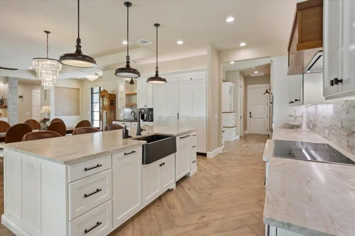 All Kitchen Countertops are Taj Mahal Quartzite. Designer Stovetop is Miele 36"Induction Cook Top, 5 Cooking Zones.  Also a 36" Miele Extra Slim Insert Hood above the stovetop...
