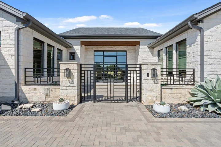 The long & winding driveway is made of paver bricks.  To the left of this courtyard are the 3 side-entry garages.