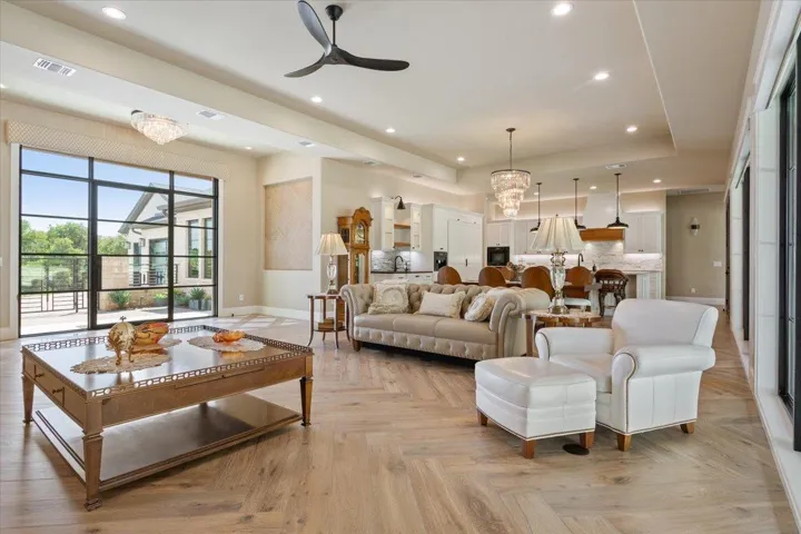 A view of the great room from the rear of the home showing the magnificent foyer, dining area, and kitchen...