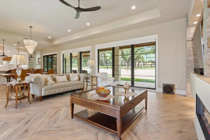 An incredible wall of Anderson windows/doors display the amazing view of the shaded back yard...