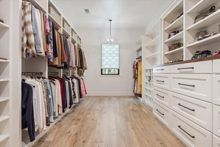 This is THE best closet off of the Primary Bathroom.  Complete with dresser drawers, built-in shelves for your shoes, purses, whatever you store...PLUS your hang up clothes...