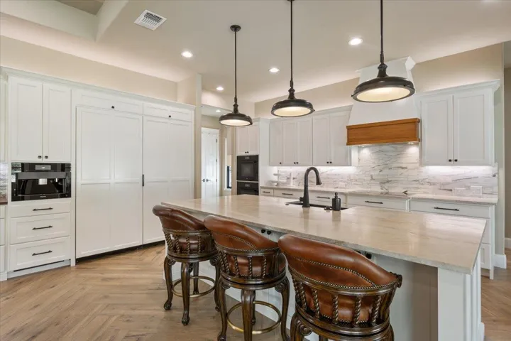 On the left is your Fully Integrated Miele 36" Refrigerator and Fully integrated Miele 36" Freezer with Ice Maker built in...both doors built in with custom panel doors...