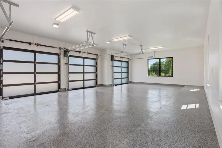 The 3 car side entry garage has commercial grade  Raynor 9' garage doors and 2 Liftmaster garage door openers plus epoxy floor...