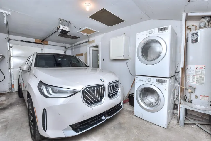 Rare attached, enclosed 1 car garage with garage door opener, EV charging and stackable washer and dryer (that convey!) There is a back door providing direct access to the private backyard!