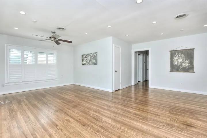 This home is flooded with an abundance of natural light. Note the plantation shutters and custom window coverings throughout!
