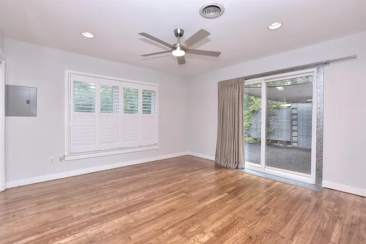 Nice primary suite with recessed lighting, vintage hardwood floors, plantation shutters and energy efficient sliding back doors that open to a private back yard entertaining space!
