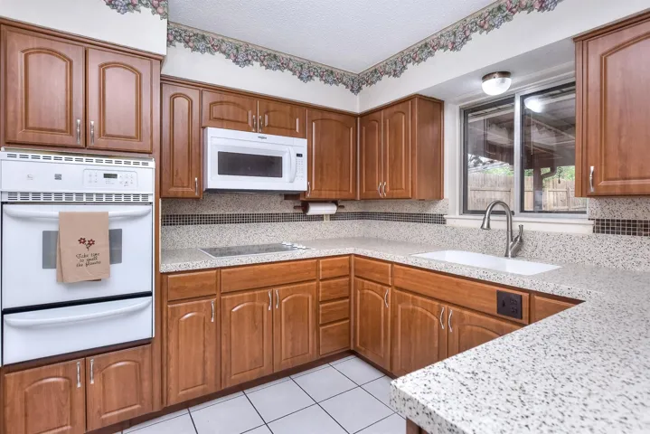 Charming but efficient kitchen offers lots of prep counter space and lots of cabinet space.