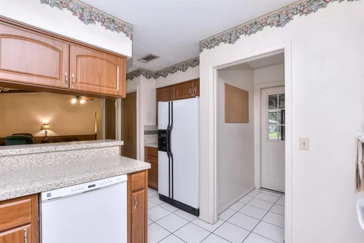 There is a nice pantry off to the left side of the refrigerator.