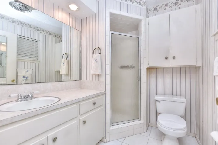 The primary bathroom has a walk-in shower and extended vanity.
