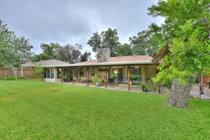 A full sprinkler system front and back keep this yard healthy, green and lush!