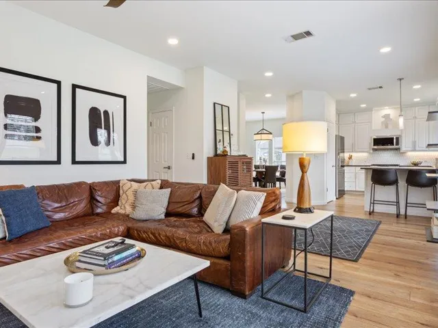 An inviting open-concept layout connects the living area with a pristine, well-appointed kitchen.