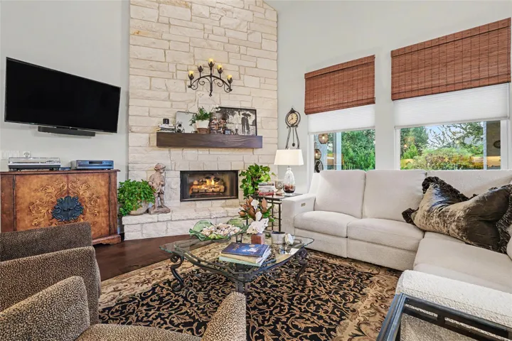 A floor-to-ceiling stone fireplace serves as the centerpiece of this inviting living room.