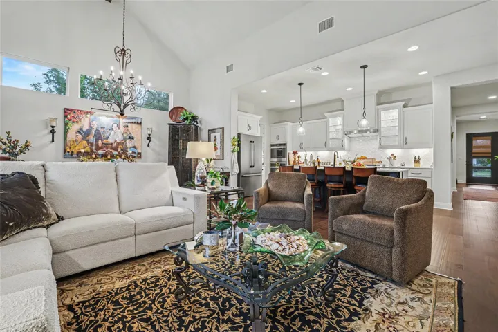 A spacious open-plan living area flows seamlessly into the light-filled kitchen under soaring vaulted ceilings.