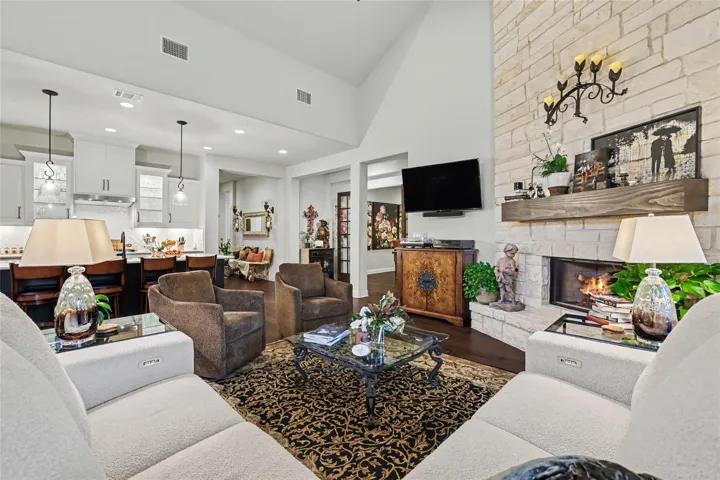 High vaulted ceilings and a stone fireplace define this open living space.