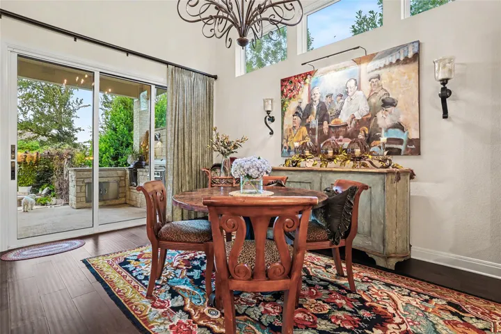 A spacious dining area features hardwood floors and sliding glass doors opening to the patio.